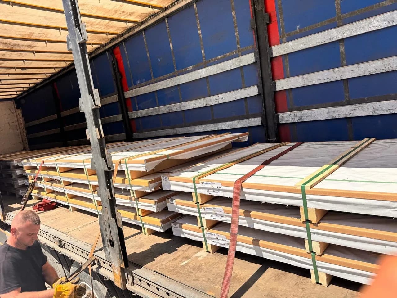 Stainless steel sheets stacked in warehouse